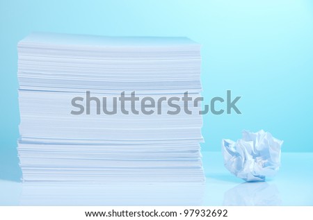 Pile of paper and small crumpled paper sheet