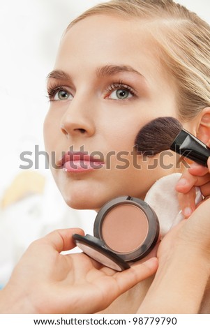 Makeup Brushes on Makeup Artist Apply Blush On Cheeks With Blush Brush Stock Photo