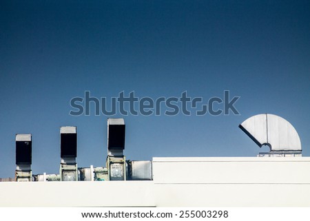 Industrial air conditioning and ventilation systems on a roof,on blue isolated.