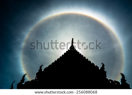 Marvelous double sun halo behind the Thai style temple roof.\
Marvelous double sun halo.