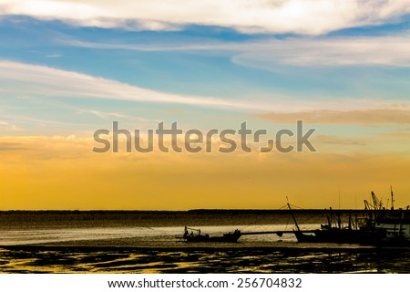 Silhouette fishing boat floating at port on sunset.\
Silhouette fishing boat.