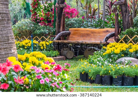 Wood chair in the flowers garden./ Flowers in the garden.
