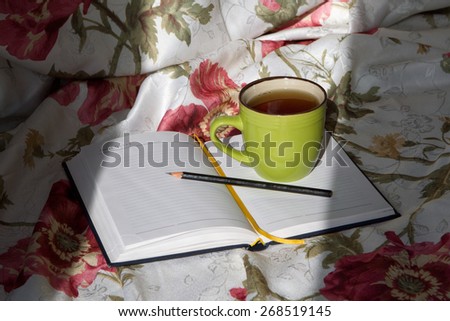 green cup of tea on the notebook pencil writing write bed reading study training linens floral print