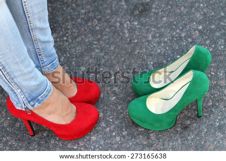 Girl\'s legs on the pavement in red high heels and green shoes heels one choice Filling