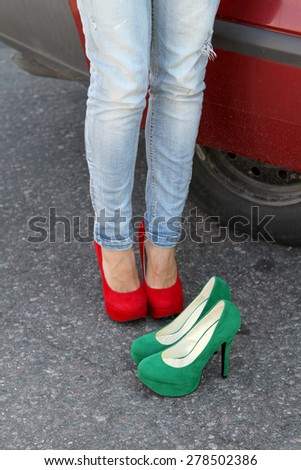 Girl\'s legs on the pavement in red high heels and green shoes heel one choice Filling