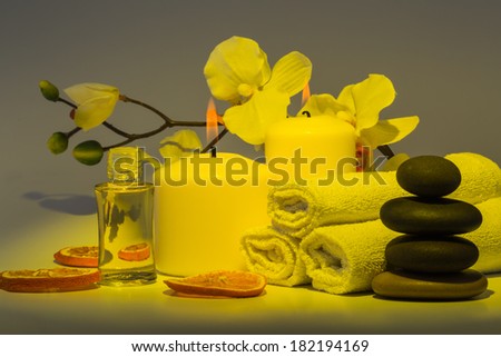 Spa still life with towels, candles and fragrances