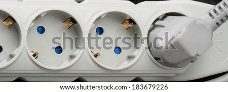 surge protector, electric outlet on a dark background