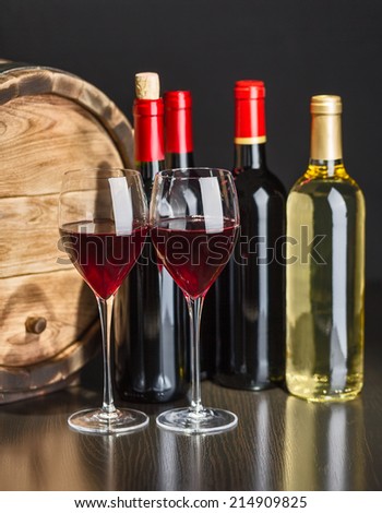 Wine still life with red wine by the glass and barrel