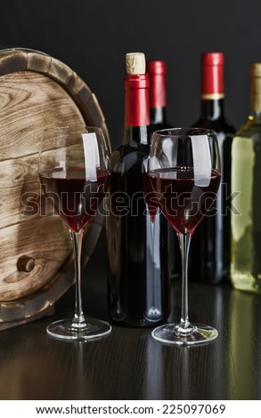 Wine still life with red wine by the glass and barrel