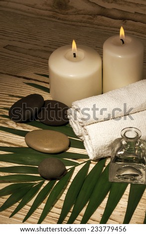 Spa still life with towels, candles and fragrances
