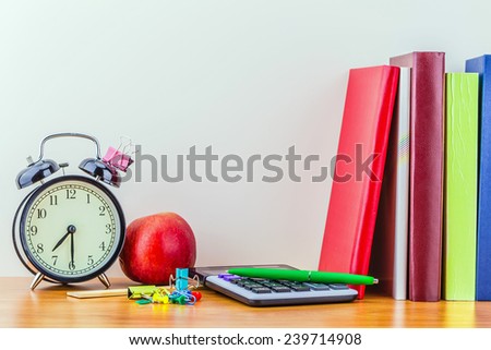 Back to school, school books with apple on desk
