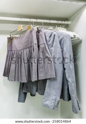 Wardrobe with clothes on hangers