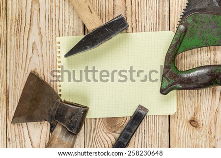 Woodworking tools, recording sheet and a wooden background