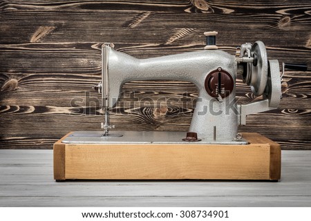 Retro sewing machine on a wooden background