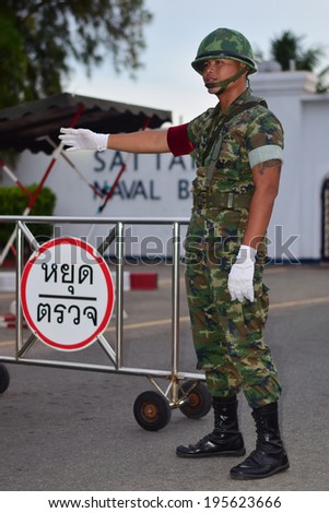 CHONBURI THAILAND-MAY 28:PVT Noparat W. security guard check all vehicle before enter the base after used martial law on May 28,2014 at Sattahip Naval Base Chonburi,Thailand.