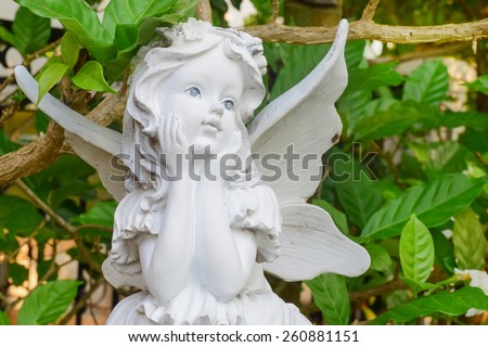 little angel sculpture decorate in small garden