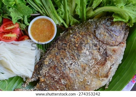 fish grilled with salt is thai food.it has many vegetable, noodles and spicy  sauce(sea food sauce)