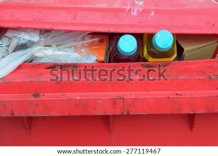 garbage in red bin.soft drink business is high competition in thailand and have many plastic bottle garbage