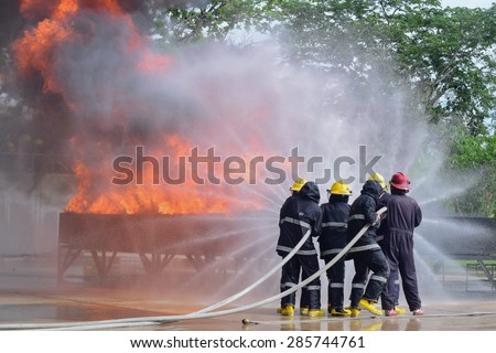outdoor fire fighter training use two water line for extinguish a fire and protect team