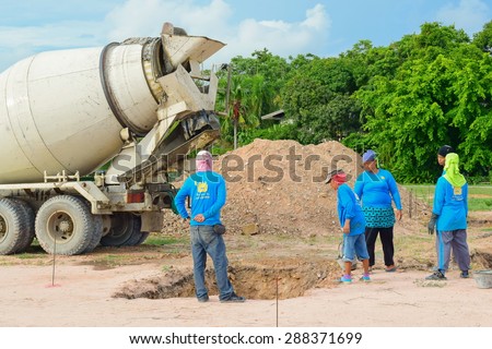 CHONBURI THAILAND MAY 8:unidentified labor working with cement truck to make main pillar of building on 8 May 2015 at Sattahip Chonburi Thailand