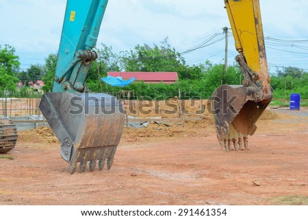 green backhoe parking in working area after work hard all day all night