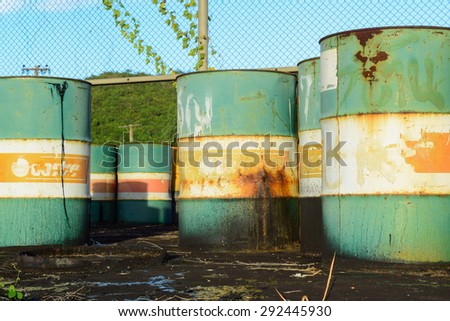 petrol garbage in rusty tank discard form factory long time ago.black oil leak and drop to ground