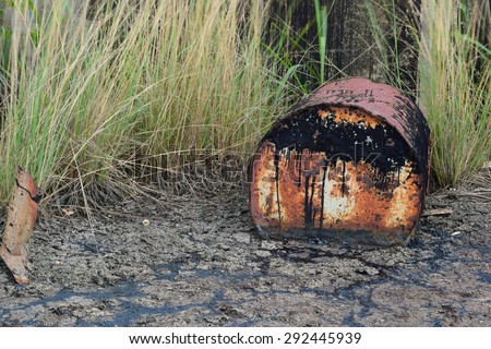 petrol garbage in rusty tank discard form factory long time ago.black oil leak and drop to ground