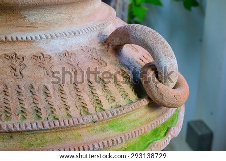 jar sculpture thai design decorate in garden.in garden wet all time good for mos growing around far