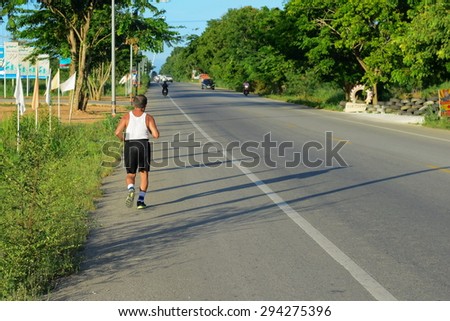 CHONBURI THAILAND 3 JULY :unidentified old man running on danger road at Sattahip Chonburi Thailand on 3 july 2015