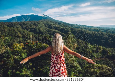 Young blonde caucasian woman traveling in the mountains, north of Bali, luxury vacation, explore and discover the world
