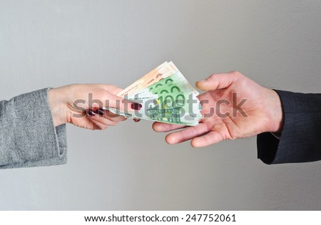 Female hand gives money, the man\'s hand takes them