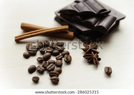Coffee beans with cinnamon sticks, star anise and chocolate