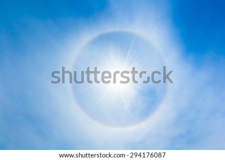 Sun halo in the sky. The sun halo is circle around the sun or the moon made from ice crystals in the sky. It is rare phenomenon