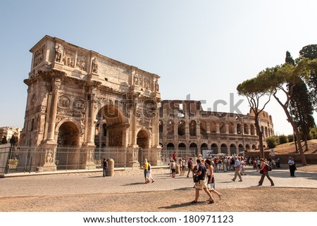 Rome, Italy - August 31, 2009: Tourists near the arch of Constantine in Rome, Italy. The Arch of Constantine is a triumphal arch in Rome, situated between the Coliseum and the Palatine Hill.