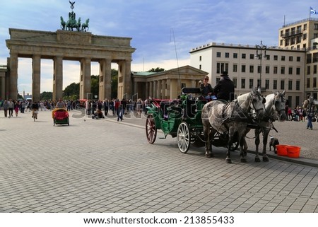 Berlin, Germany - AUG, 22: Horse-drawn carriage in front of Brandenburger tor on August, 22, 2014. Berlin, Germany