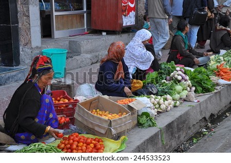 Leh, INDIA - AUG, 8: Market scene on August, 8 2011 in Leh, India. Local women sell fruits and vegetables on the street. Ladakh has harsh climate for food industry, most of them are imported.