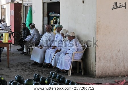 Nizwa, Oman - Dec, 31: old arab man sit outside the daily market in Nizwa on December, 31, 2013. Nizwa, Oman