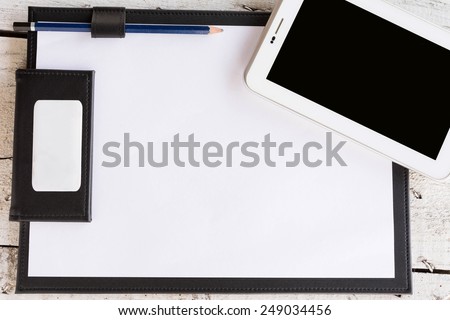 Working  board text frame for your text with mobile phone on wooden table