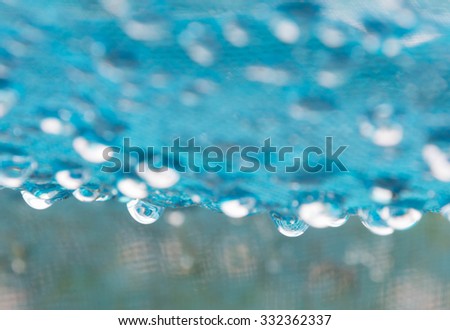 soft focus of raindrop on blue net after raining