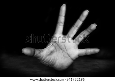 hand of Fear woman being abuse on ground with man on her body and holding her hairs ( abuse concept, sexual abuse)with black shadow  in white tone