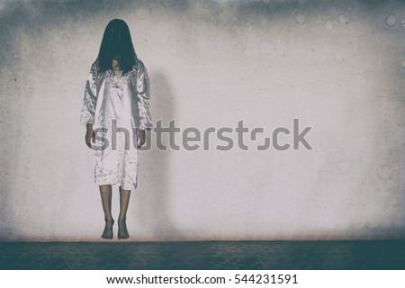 Mysterious Woman, Horror scene of scary ghost woman holding doll on white wall with black shadow