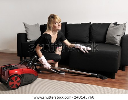 Cleaning lady vacuuming couch