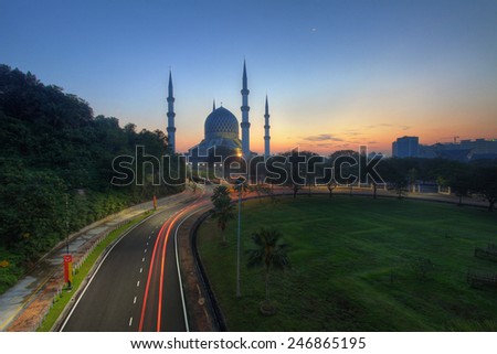 Light trail at busy highway with the view Shah Alam Mosque