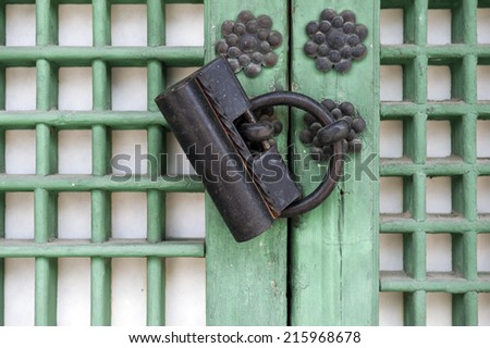 Old rusty lock on the wooden gate