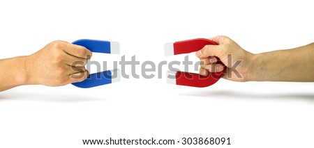 Two people pull holding magnets