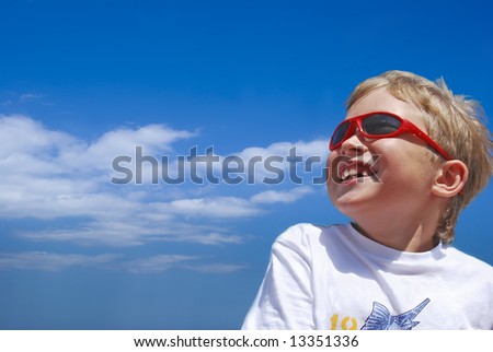The blue sky. The cheerful boy is dared
