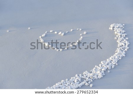 Close up of white stones, pebbles with heart,wedding entrance