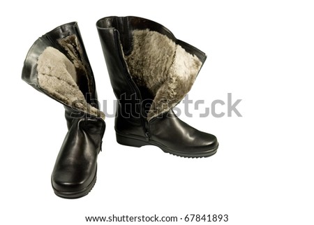 Black leather winter boots with fur. On a white background