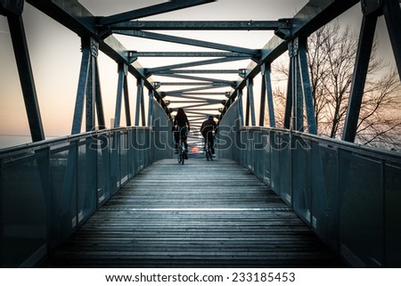 Bicycles on the bridge at sunset