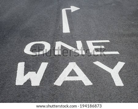 one way sign on tarmac road with arrow pointing right